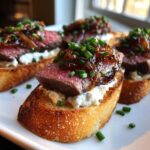 Close-up of gourmet steak crostini topped with rare steak, creamy cheese, caramelized onions, and chives.